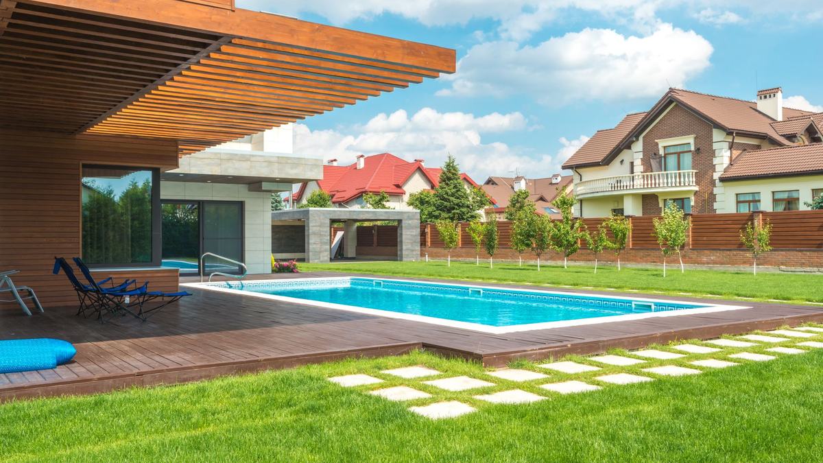 Modern landscaped Perth backyard with lawn, pool and paving